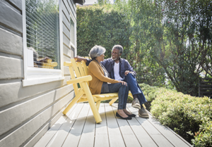 Elderly couple chats on porch